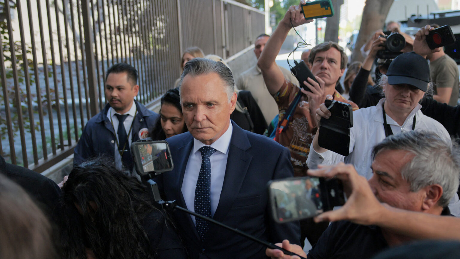 Attorney Patrick Steinfeld surrounded by media personnel while walking to a Los Angeles courthouse.